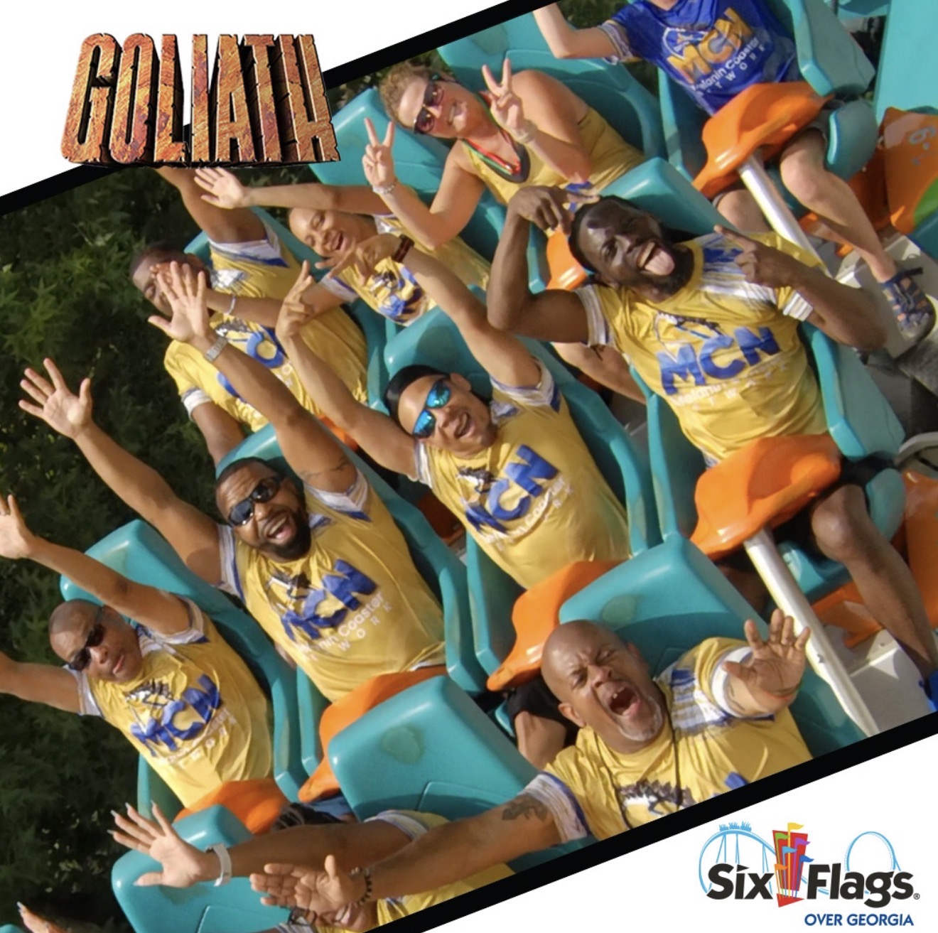 Group of people on a roller coaster ride, raising hands, wearing yellow shirts, with excitement and smiles.