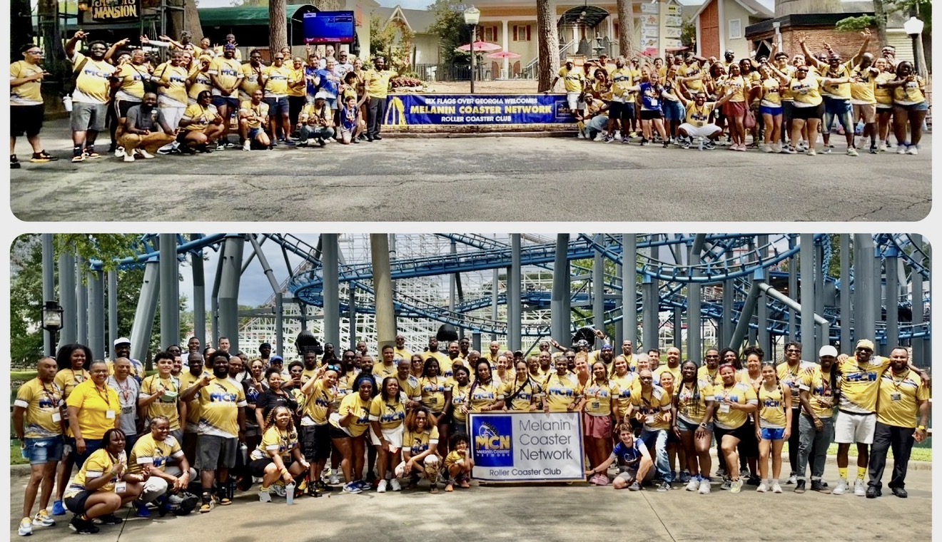 Large group of people wearing yellow shirts gathered outdoors, holding banners and signs, with buildings and structures in the background.