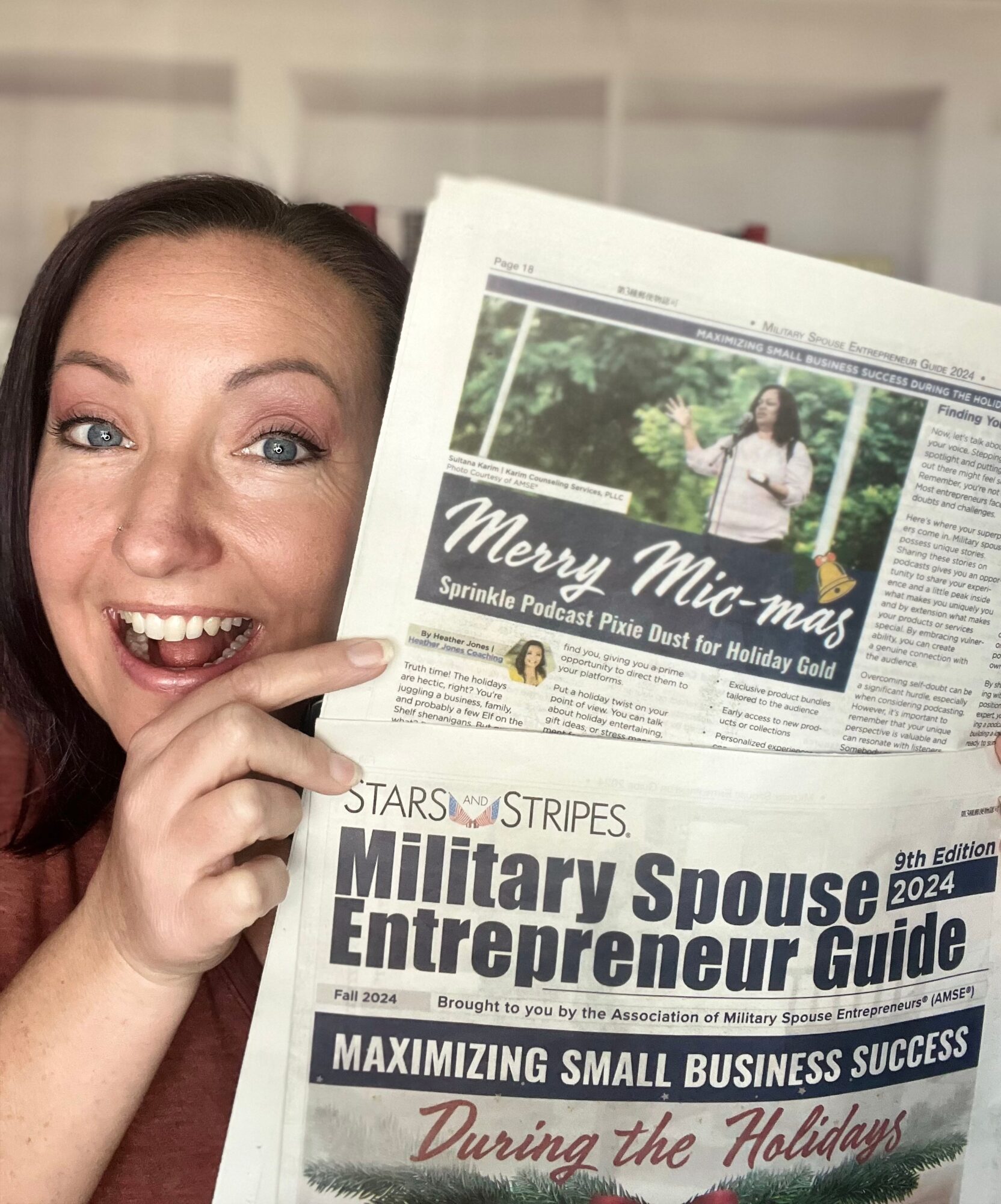 Woman holding a newspaper with a headline about military spouse entrepreneurs during the holidays, smiling and pointing at it.