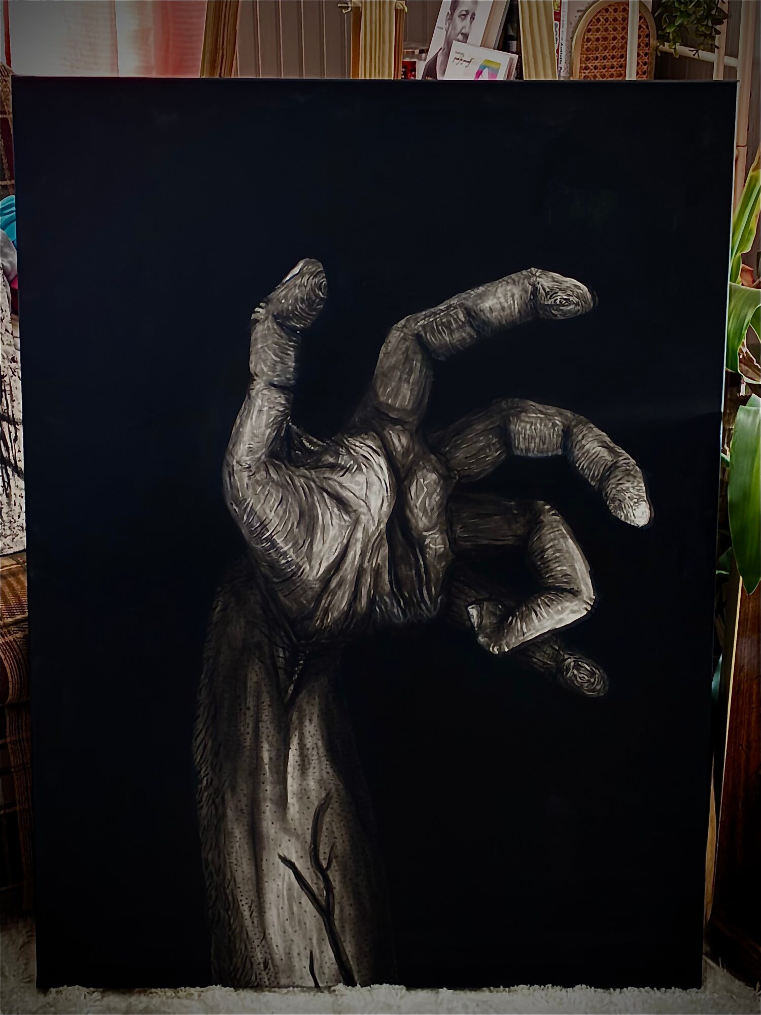 A detailed black and white drawing of a hand with fingers curled, set against a dark background.